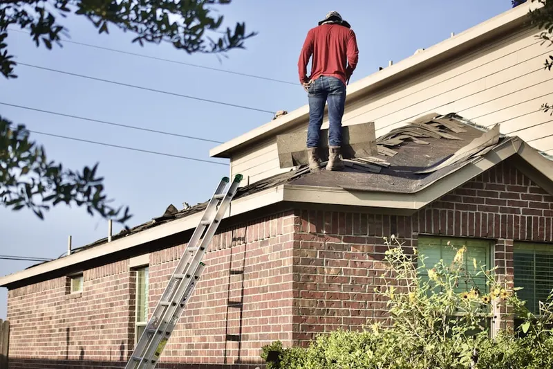 Professional roofer working on a residential roof in Pines of Laurel